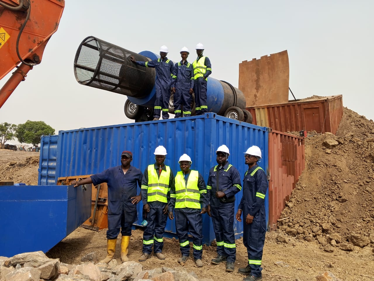 Aurelia team beside mining equipment at Babban Tsauni